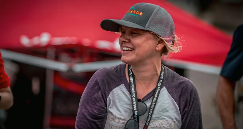 A smiling volunteer at a community event