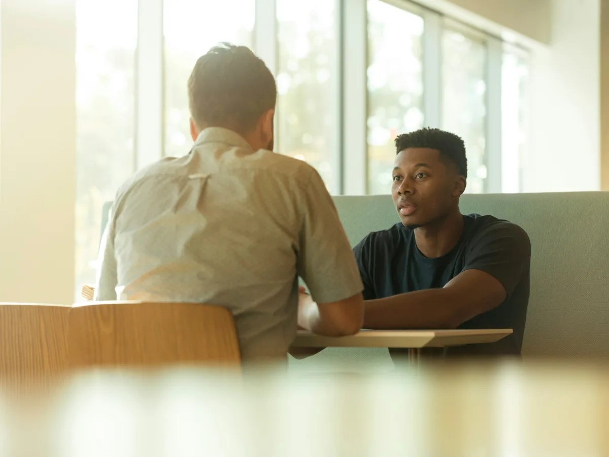 A mentor and a young professional talk one-on-one