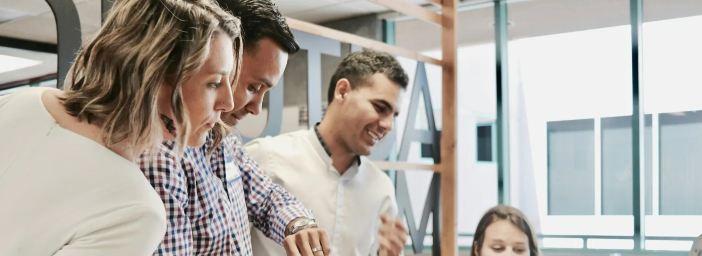 A team shares a laugh during a meeting